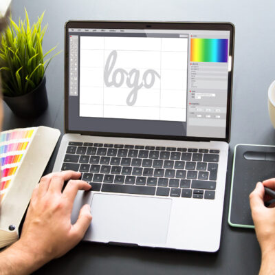 graphic designer working on laptop mock up